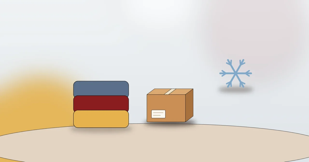 Polsterdecken, Umzugskarton und Schneeflocke als Symbol für den Schutz von Möbeln vor Nässe und Frost