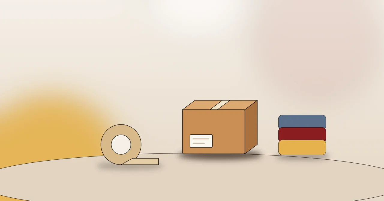 Umzugskarton, Packband und Polsterdecken als Symbol für hochwertiges Packmaterial