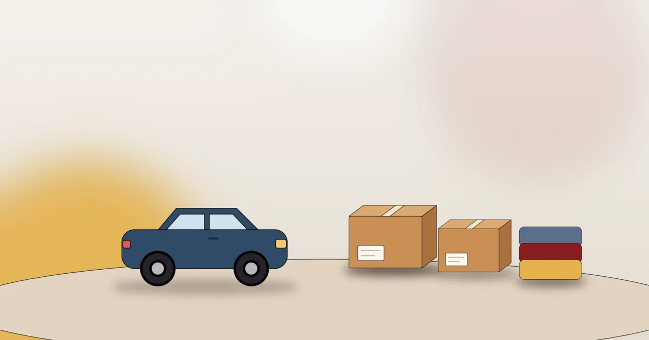 Auto mit Umzugskartons und Polsterdecken als Symbol für richtiges Beladen und Ladungssicherung